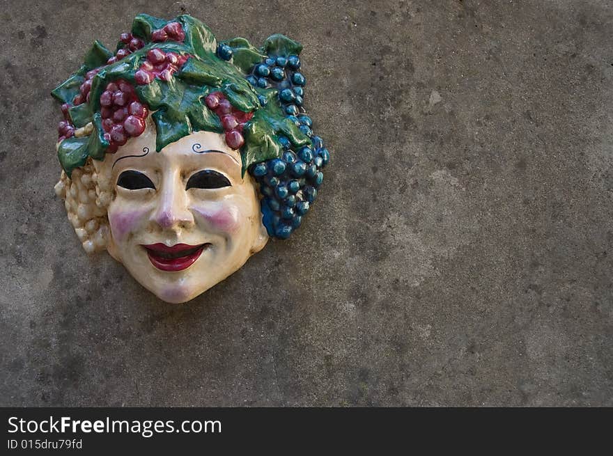 Face on the wall in front of a wine shop.