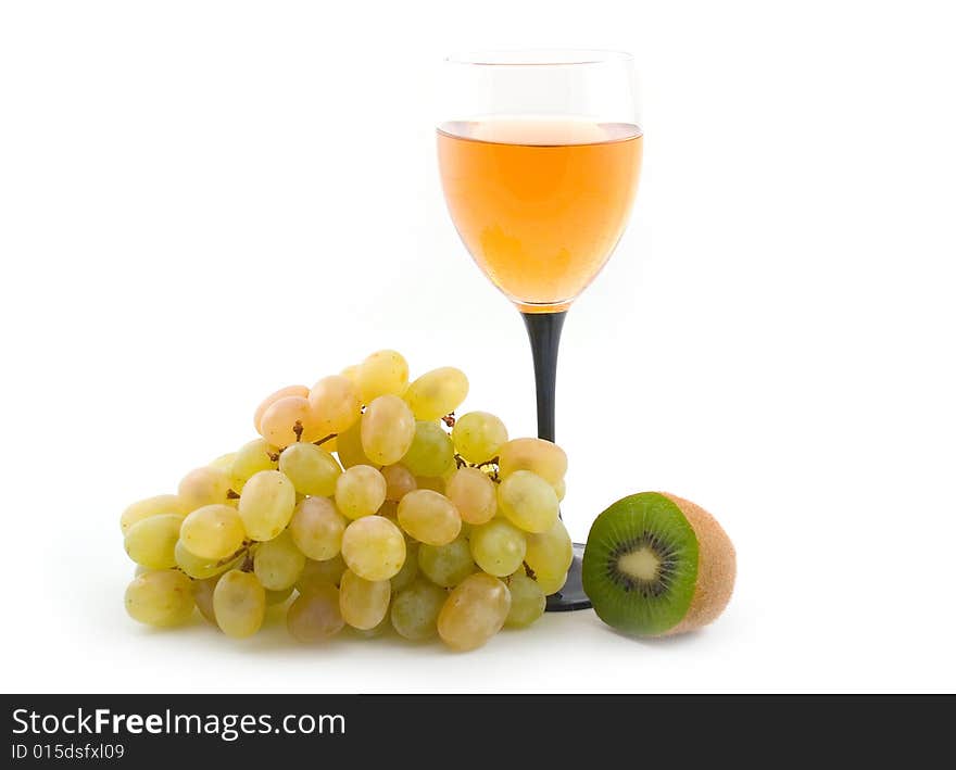 Light wine and grapes with a green fruit on white background