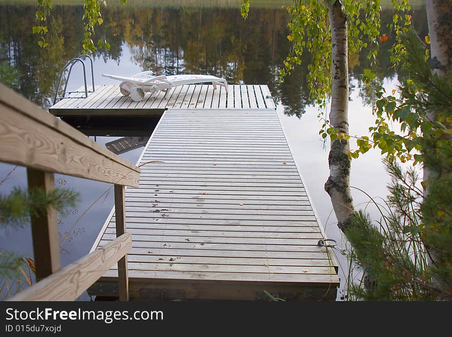 Lake, deckchair on the pier. Lake, deckchair on the pier