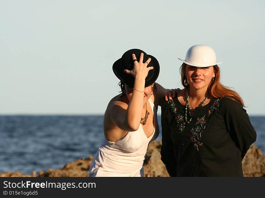 Two young women with balck and white hats. Two young women with balck and white hats