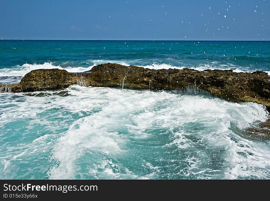 Rocks, waves and tropical sea