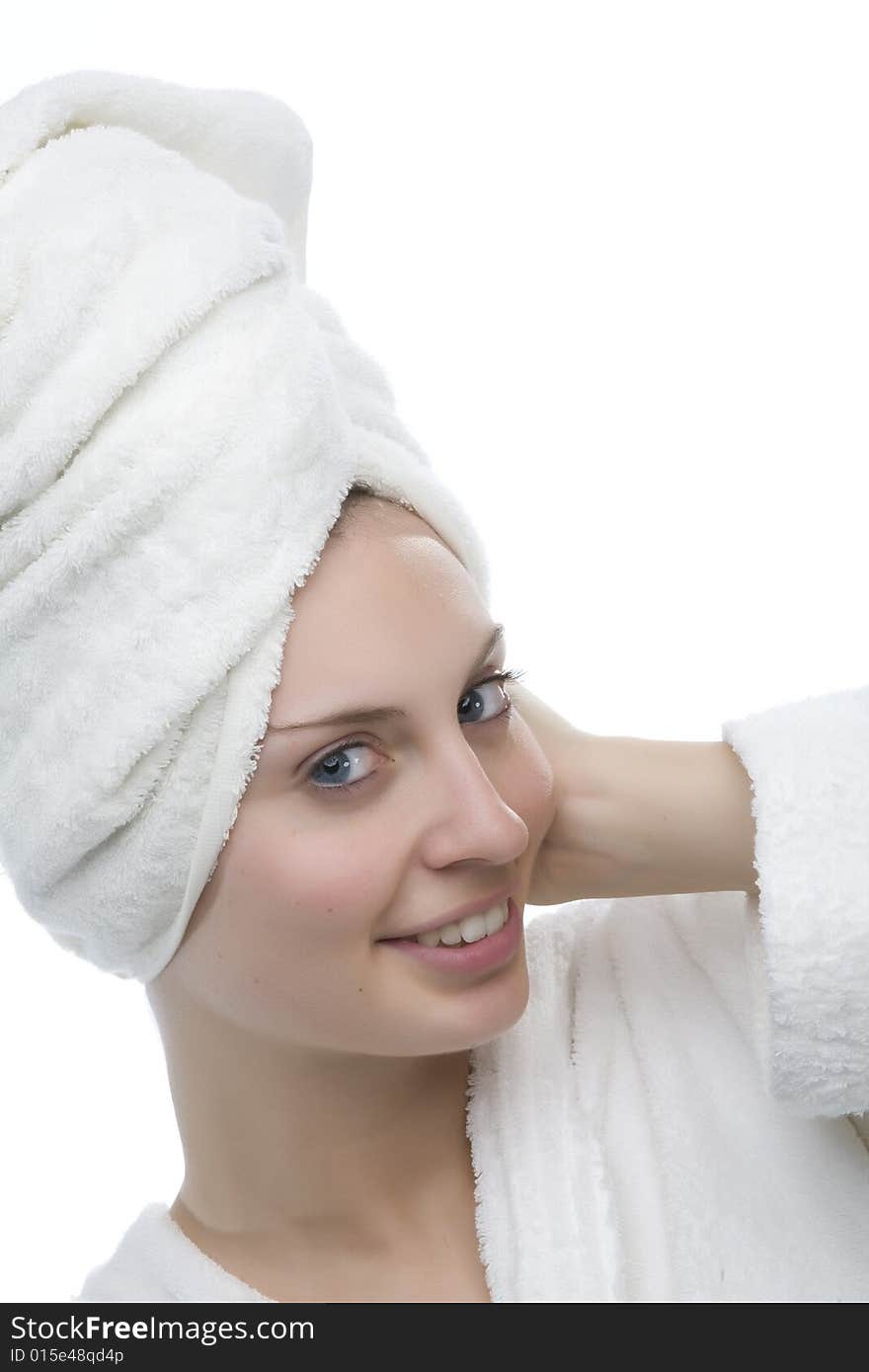 Young and smiling girl wearing a white bathrobe. Young and smiling girl wearing a white bathrobe