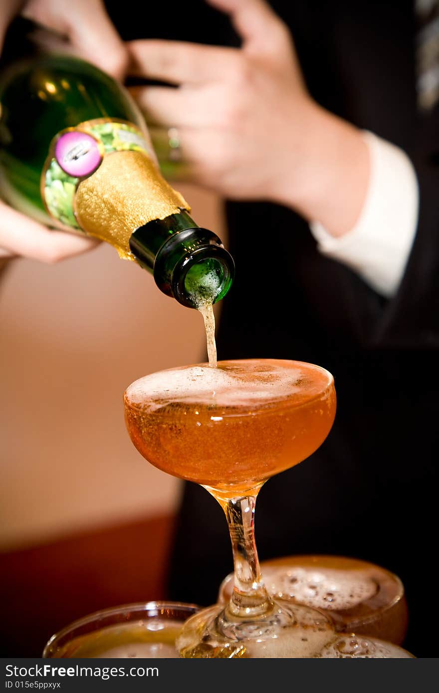 Groom pouring champagne on their wedding ceremony