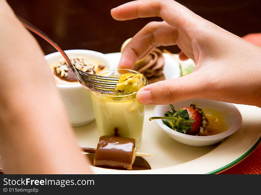 Woman Scooping Her Dessert With Folk