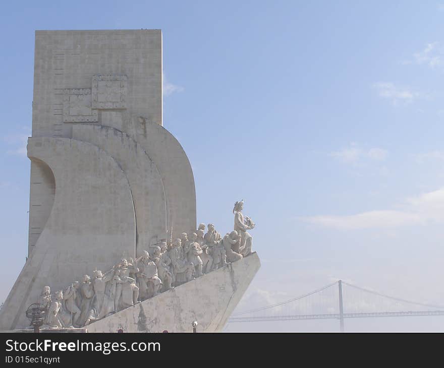 Lisbon Discoveries Monument with bridge in back ground in Lisbon