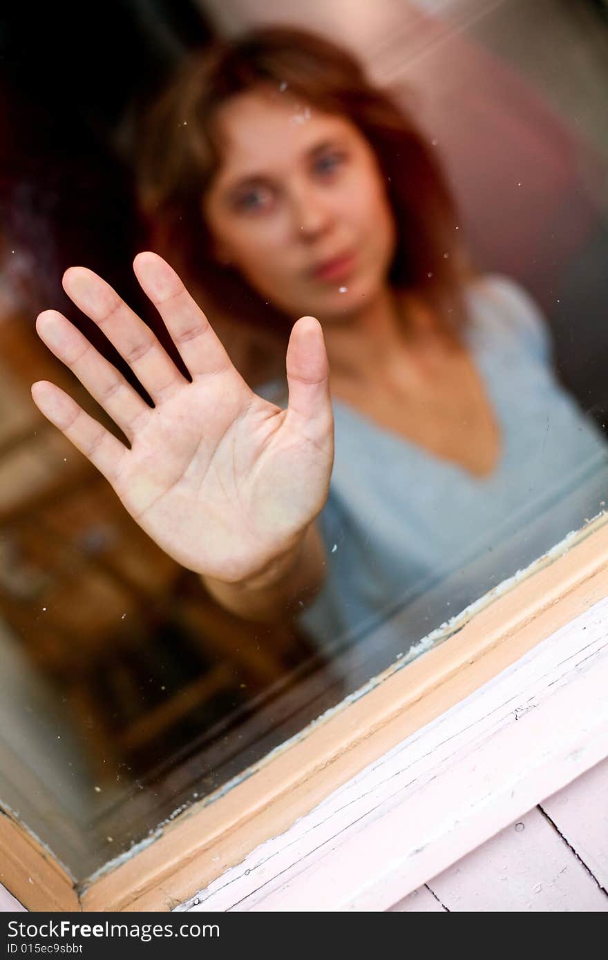 Young women with outstretched hand. In the glass. Young women with outstretched hand. In the glass.