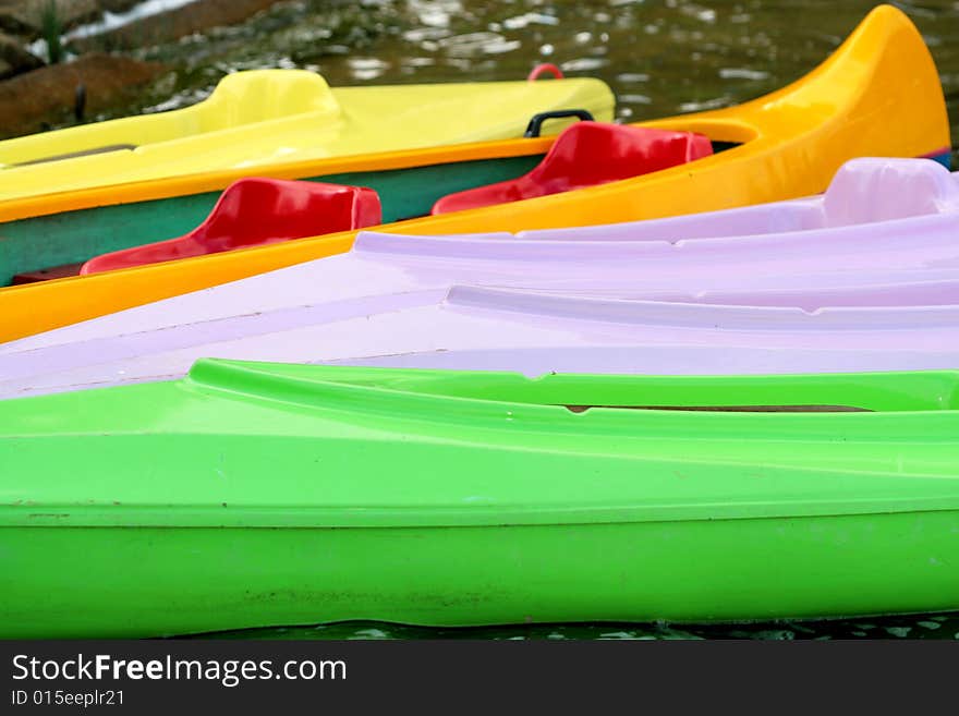 Coloured Canoes Ashore Of The Lake