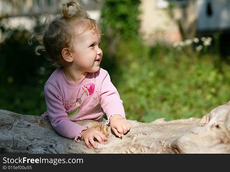 An image of  baby girl playing outdoor