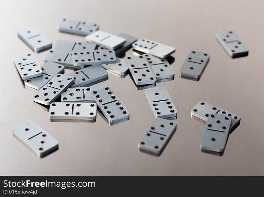 Steel dominoes on a polished surface