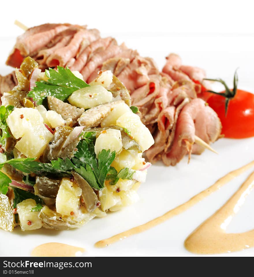 Roast Beef Served with Salad (Potatoes and Vegetables) and Cherry Tomato. Isolated on White Background