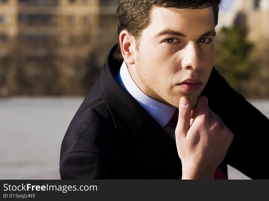 Handsome businessman portrait in pensive gesture