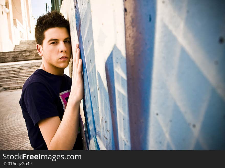 Young man portrait over grafted wall. Young man portrait over grafted wall.