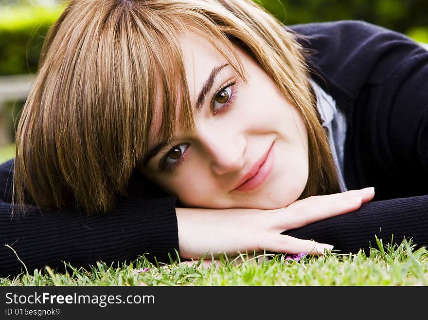 Smiling beauty on grass