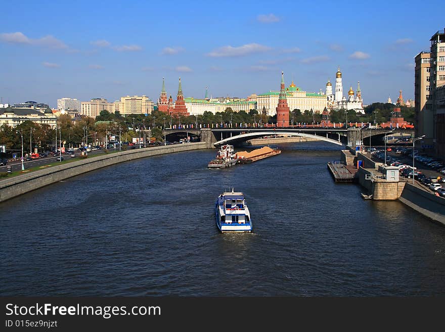 Kind from the bridge on the river with floating on it a vessel, on a background, the Moscow Kremlin. Kind from the bridge on the river with floating on it a vessel, on a background, the Moscow Kremlin