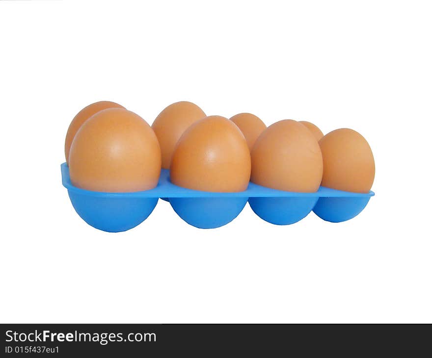 Eggs on a white background in a dark blue tray