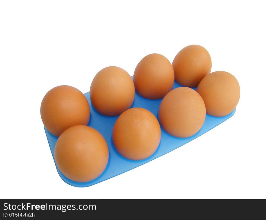 Eggs on a white background in a dark blue tray