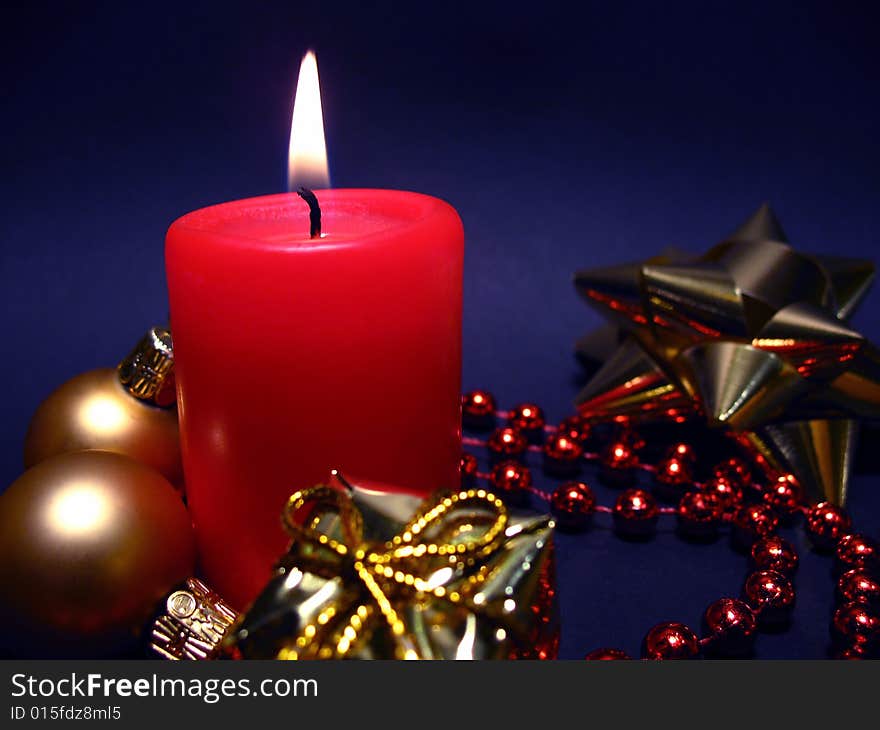 Red candle on black background, Christmas still life with candle, balls and present