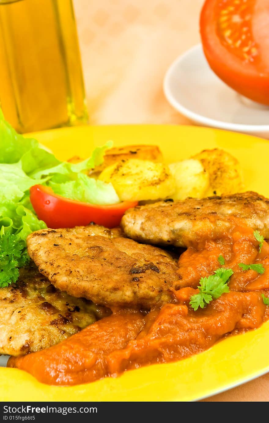 Baked hamburger with tomato sauce,fried potatoes ,salad.