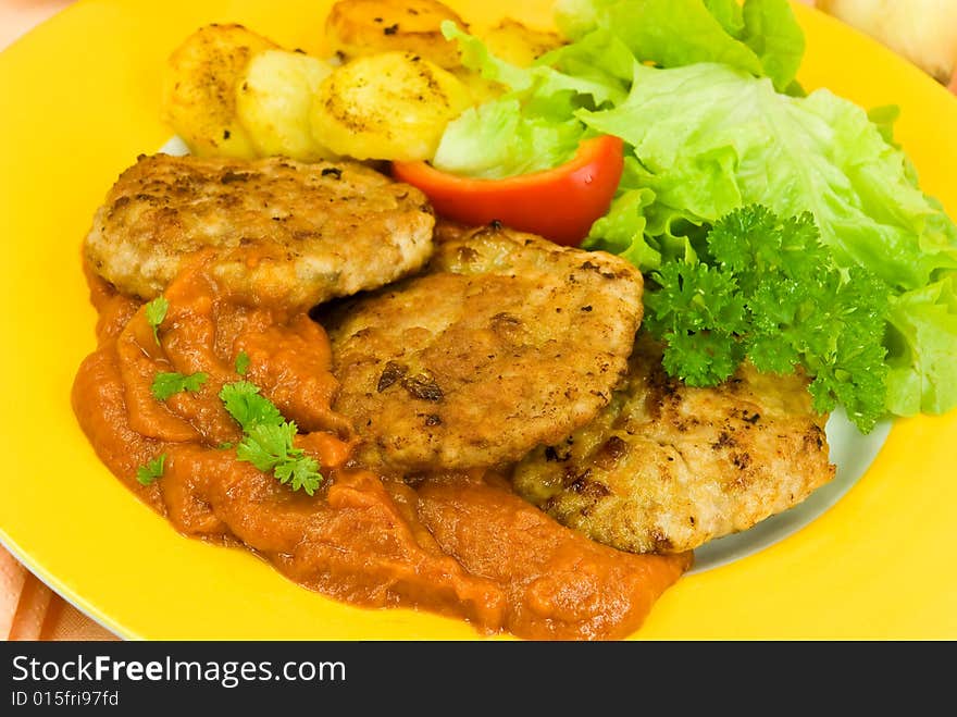 Baked hamburger with tomato sauce,fried potatoes ,salad.