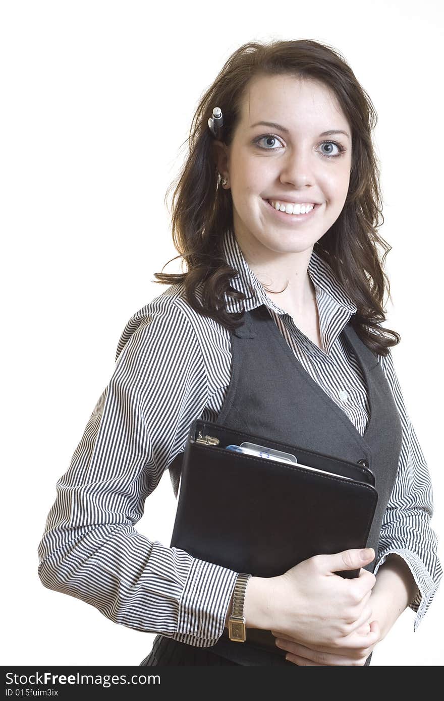 A professional businesswoman smiling and holding a day planner