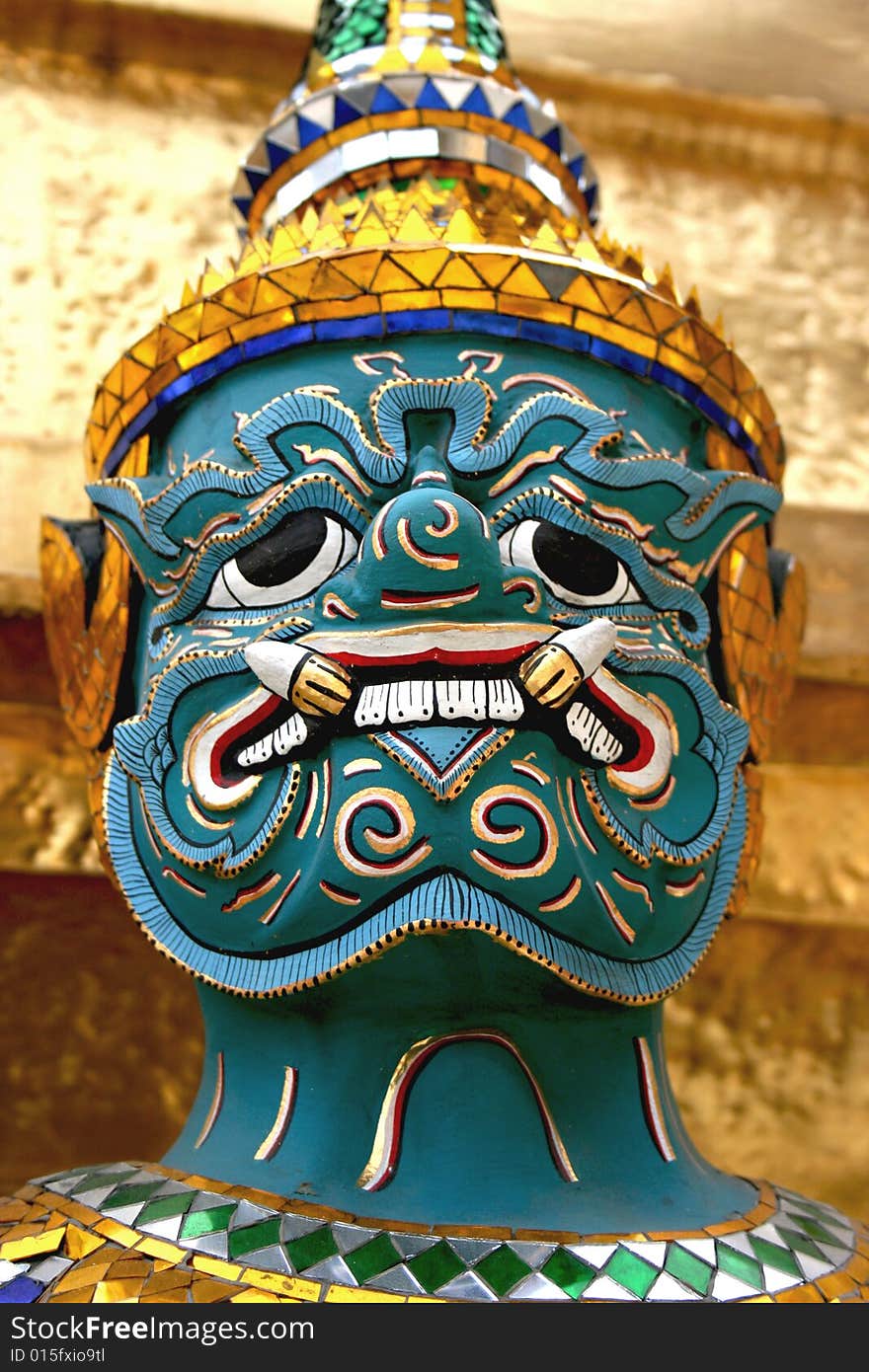 A close-up of a yaksha warrior outside a Thai temple