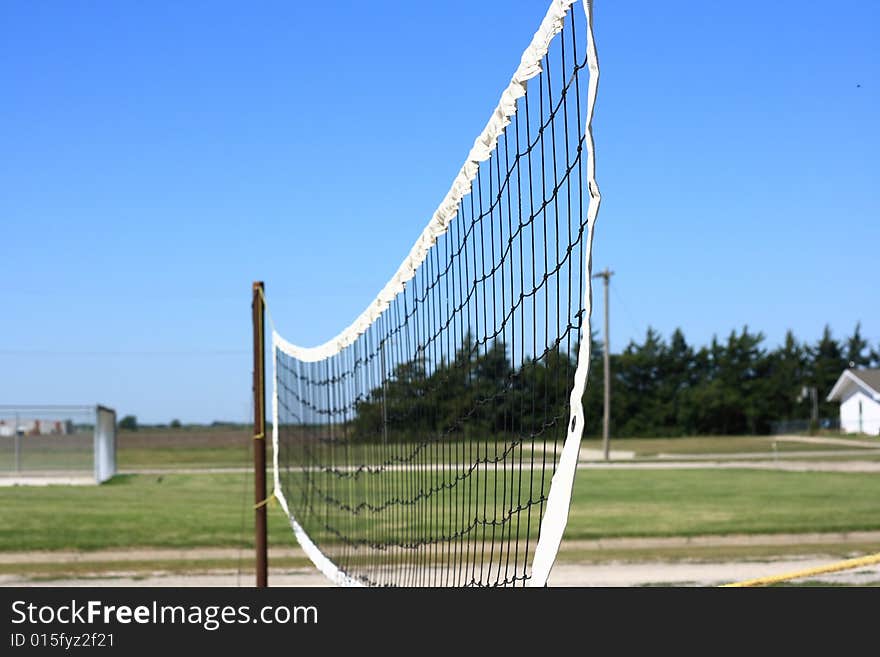 An outdoor volleyball net in a city park.