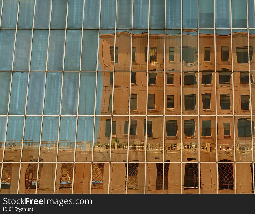 An old building reflected in a new one. An old building reflected in a new one