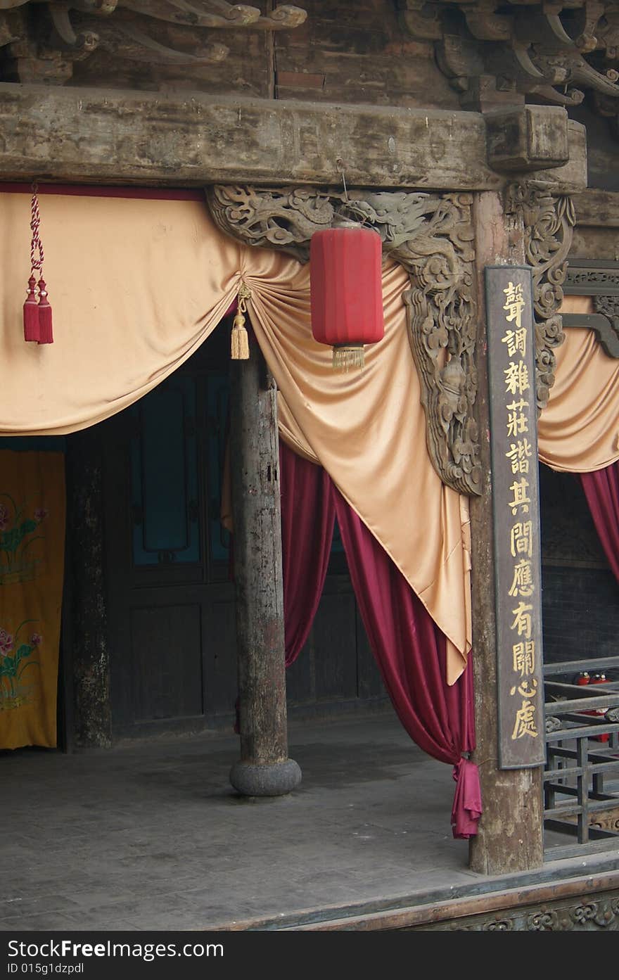 Tradition stage,there are distich and a red lantern on it,it's in West of China.