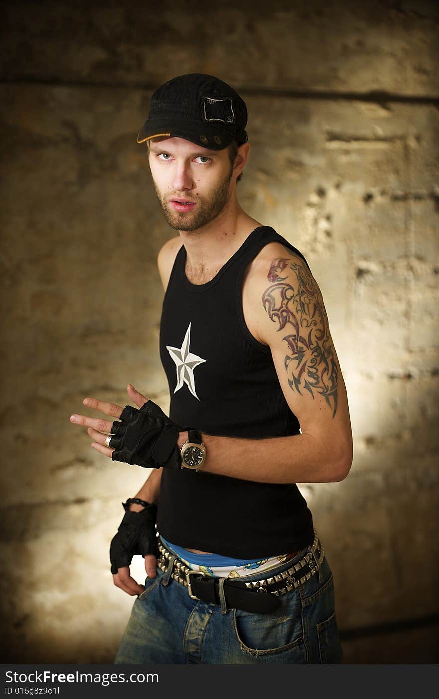 Young fellow in the tattooings on the ruins