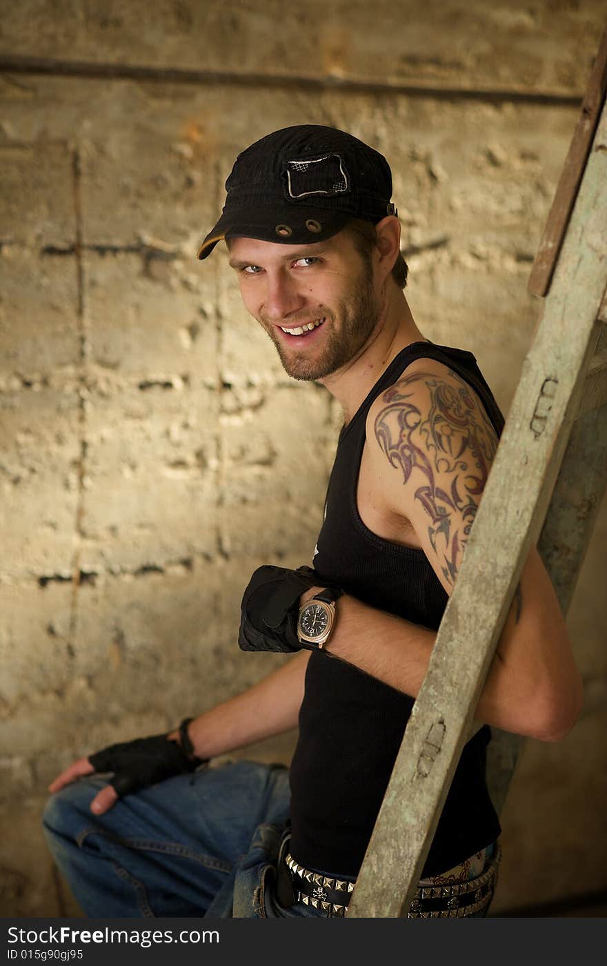 Young fellow in the tattooings on the ruins