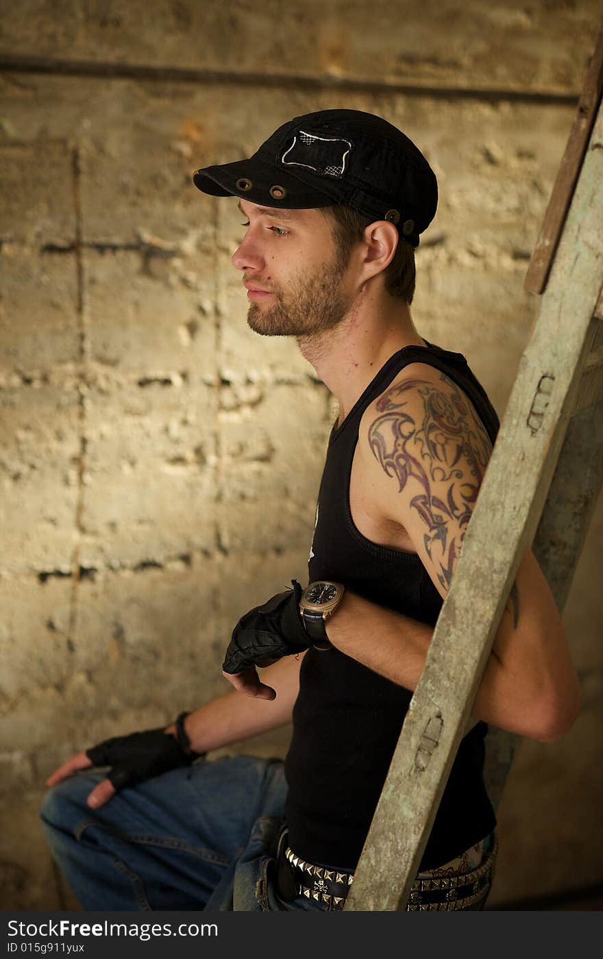 Young fellow in the tattooings on the ruins