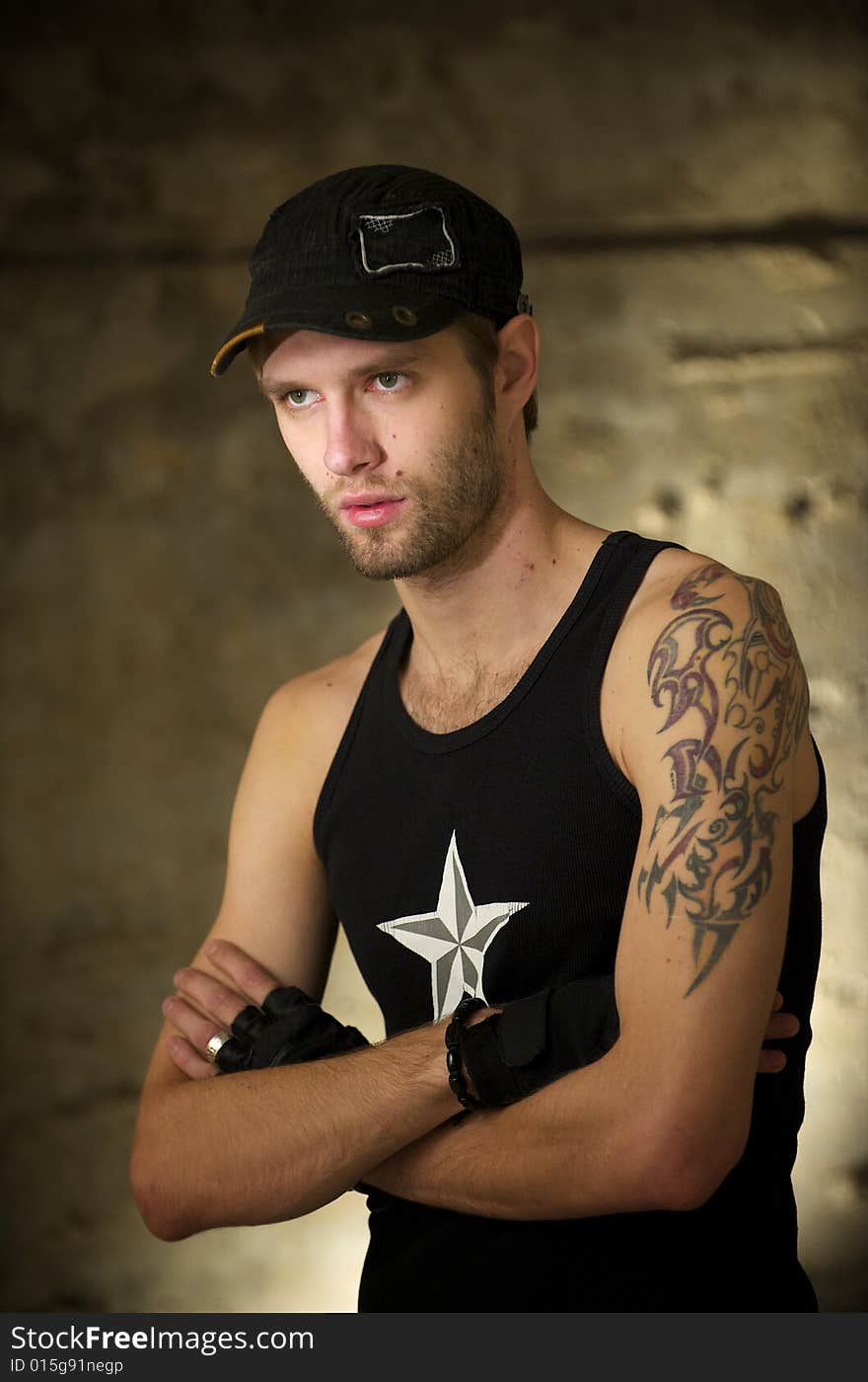 Young fellow in the tattooings on the ruins