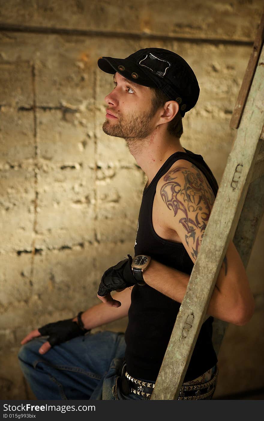 Young fellow in the tattooings on the ruins