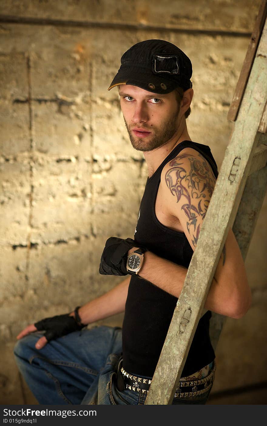 Young fellow in the tattooings on the ruins