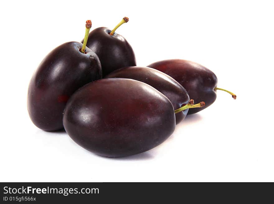 Several plums isolated on white background