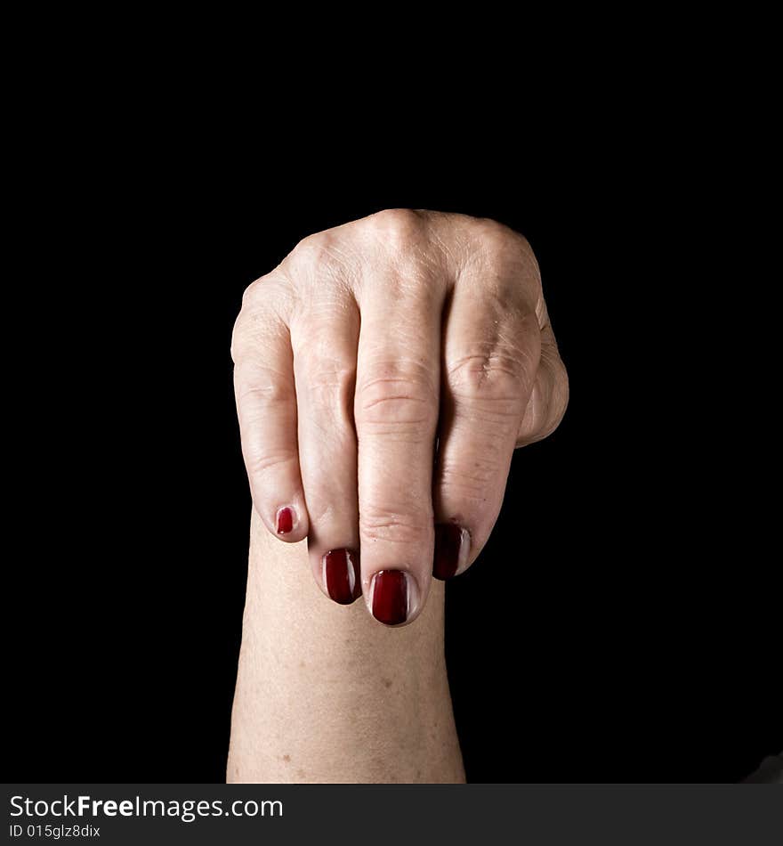 Older hand with painted nails on black background