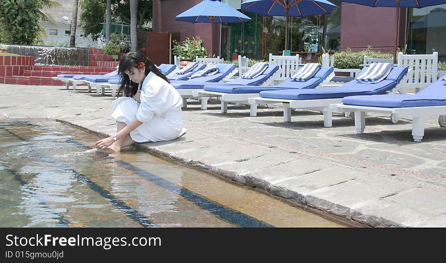 The woman relaxing at hotel pool. The woman relaxing at hotel pool