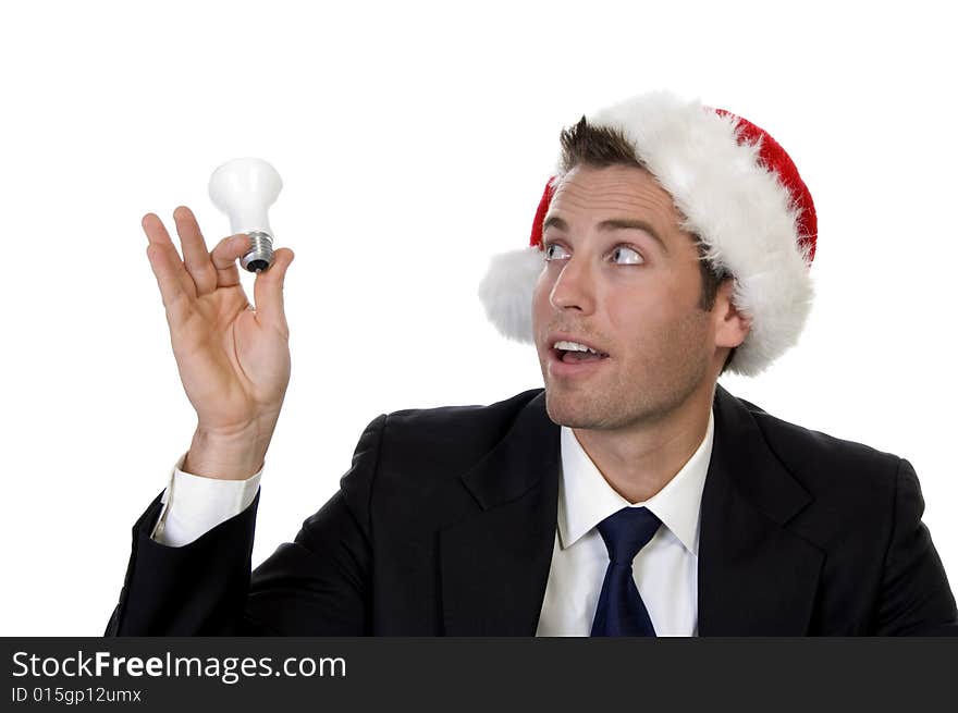 Businessman looking bulb and wearing santacap