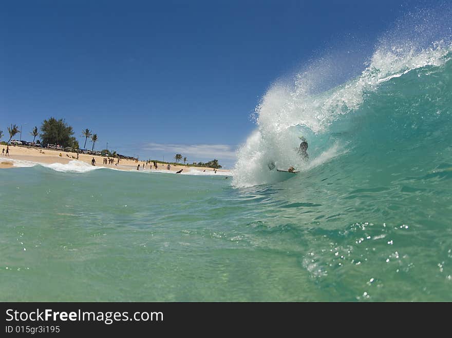 A bodyboarder getting barrel in hawaii