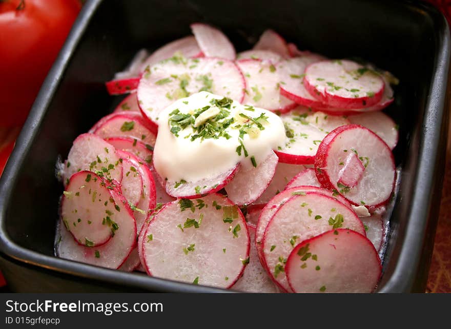 A salad of red radishes with some spices