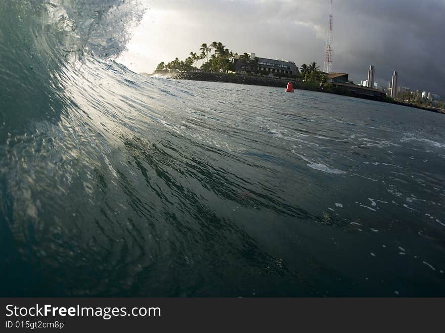 A wave about to break with the sun in the back