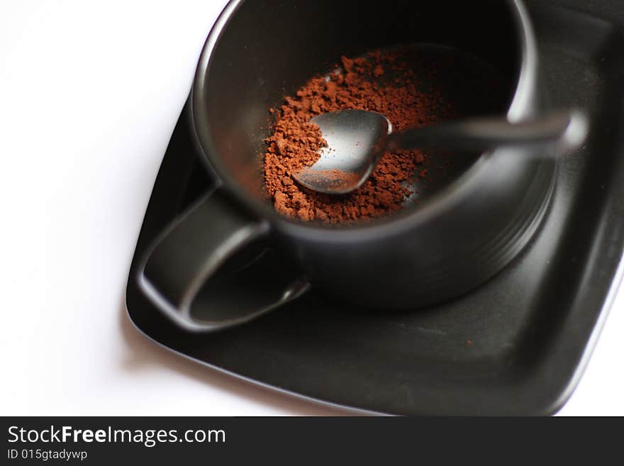 A cup of coffe without water against a white background.