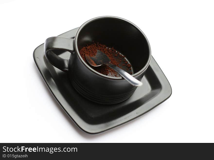 A cup of coffe without water against a white background.