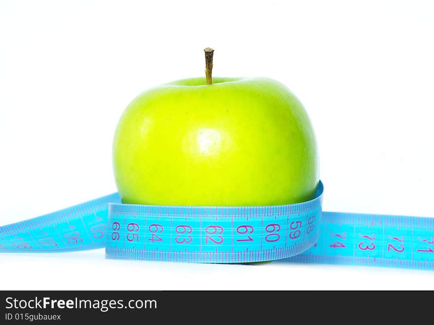 Green apple and measuring tape on white