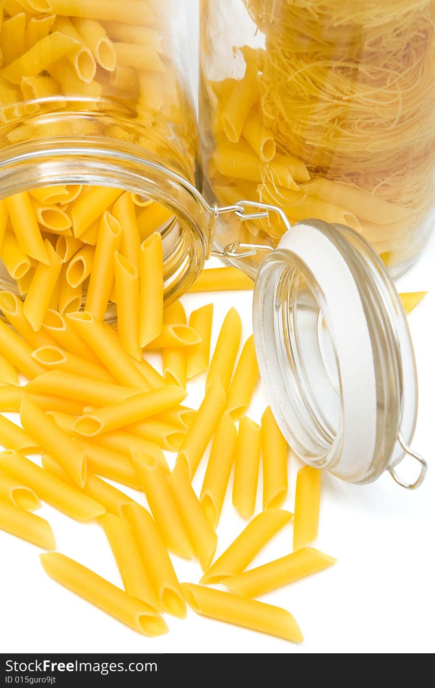 Pasta in glass can on a white background