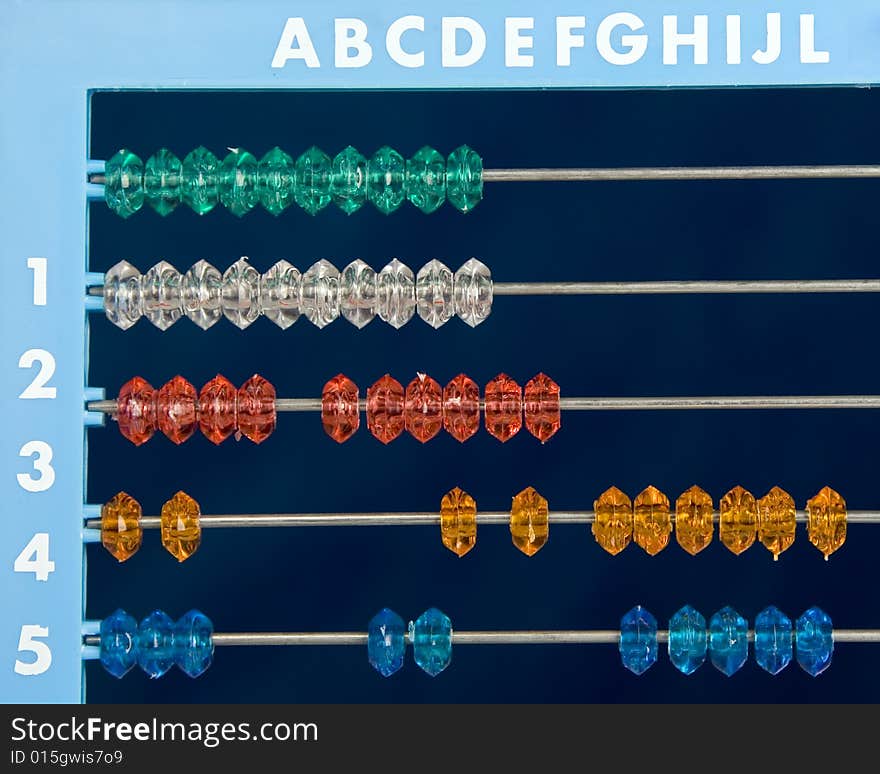 Colored abacus over dark blue background