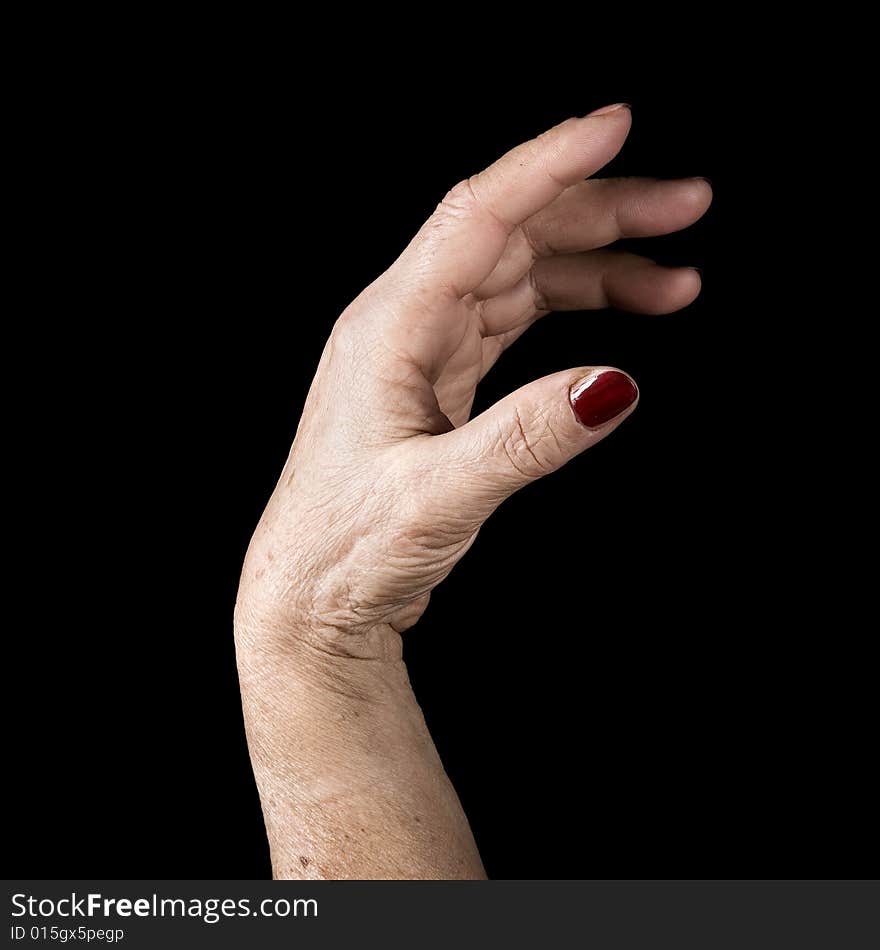 Older hand with red painted nails on black background. Older hand with red painted nails on black background