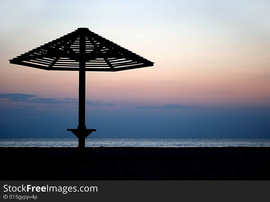 Beach umbrella silhouette on sunset. Beach umbrella silhouette on sunset