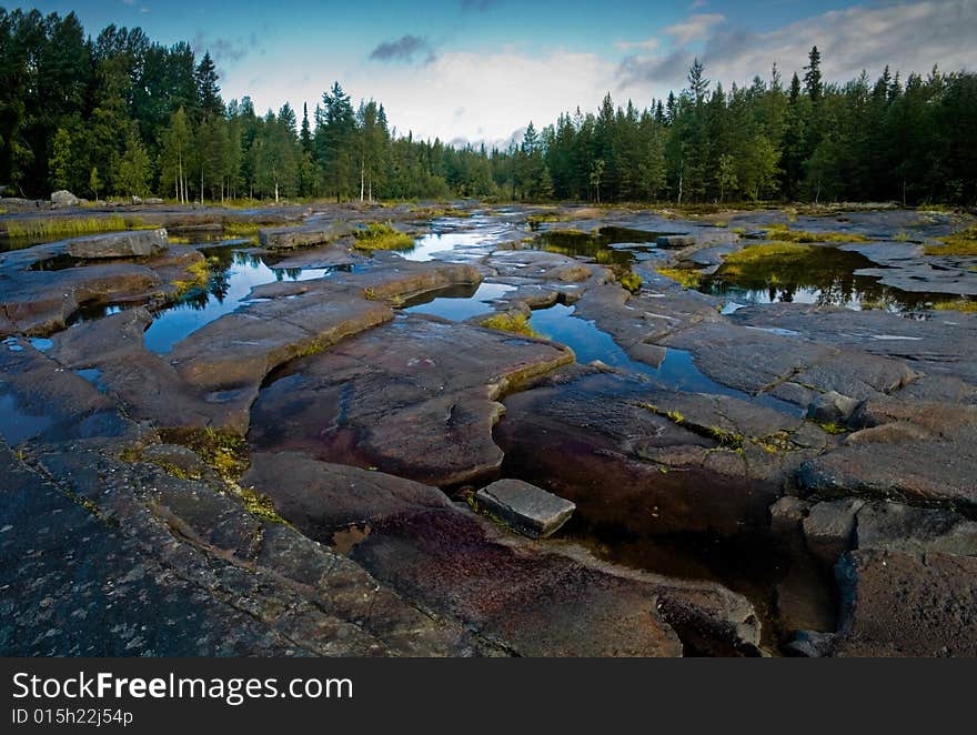 A view of the place where wild rocky surface spotted with water. A view of the place where wild rocky surface spotted with water