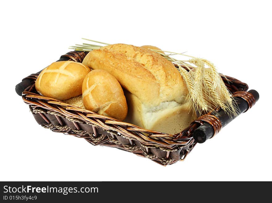 Basket of wheat bread, buns and wheat ears. Basket of wheat bread, buns and wheat ears.